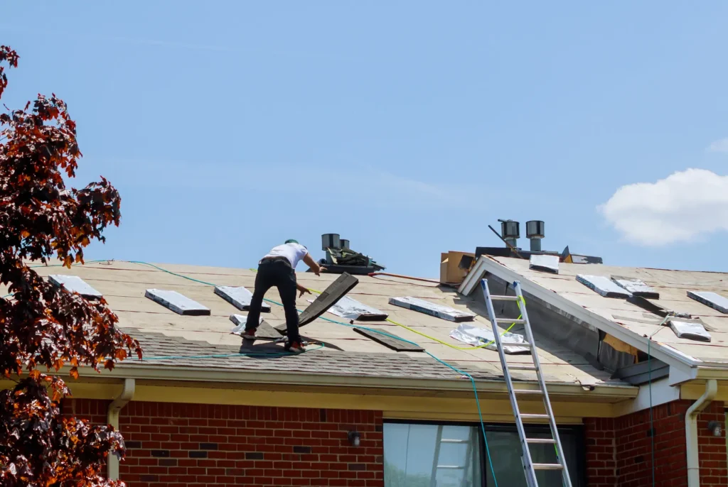 Roofer installing shingles on a roof for long-lasting durability.