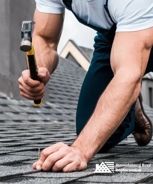 Roofer repairing shingles on a residential roof for reliable protection.